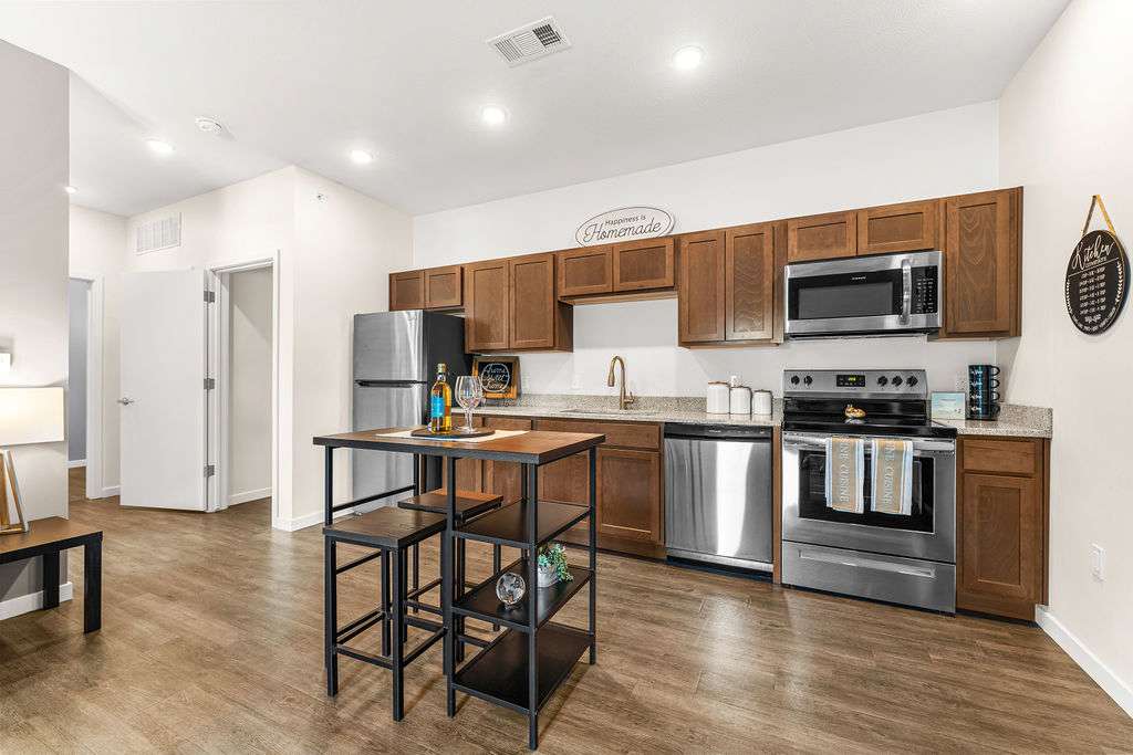 Lofts at Fox Ridge kitchen with island and stainless steel appliances - Raymore, MO