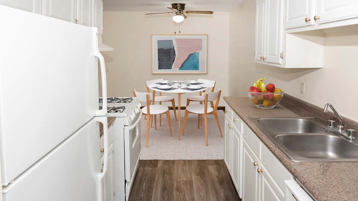 River Pointe Apartments kitchen with white cabinetry - Fridley, MN
