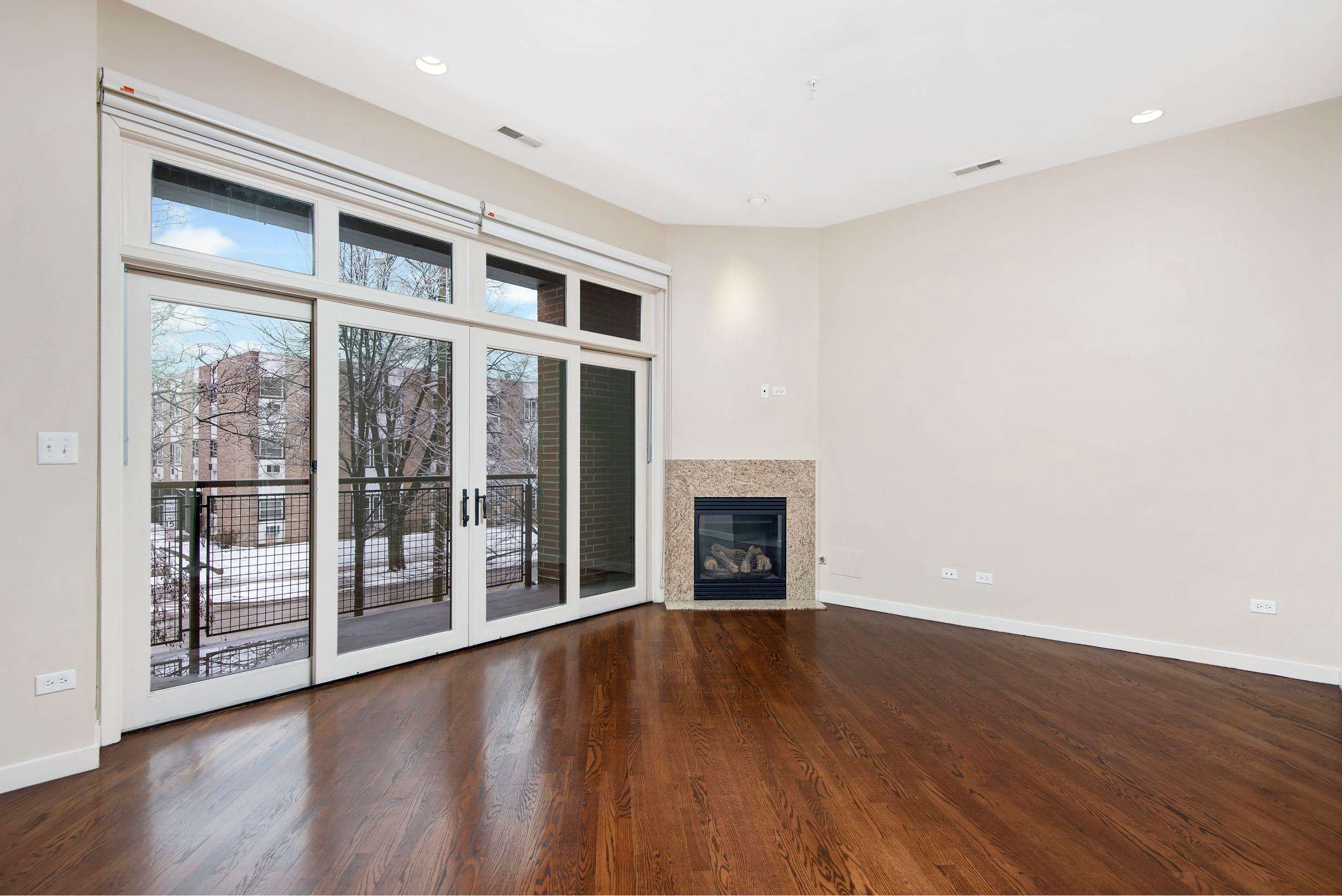 Oak Park Place apartment living area with fireplace and patio doors - Oak Park, IL
