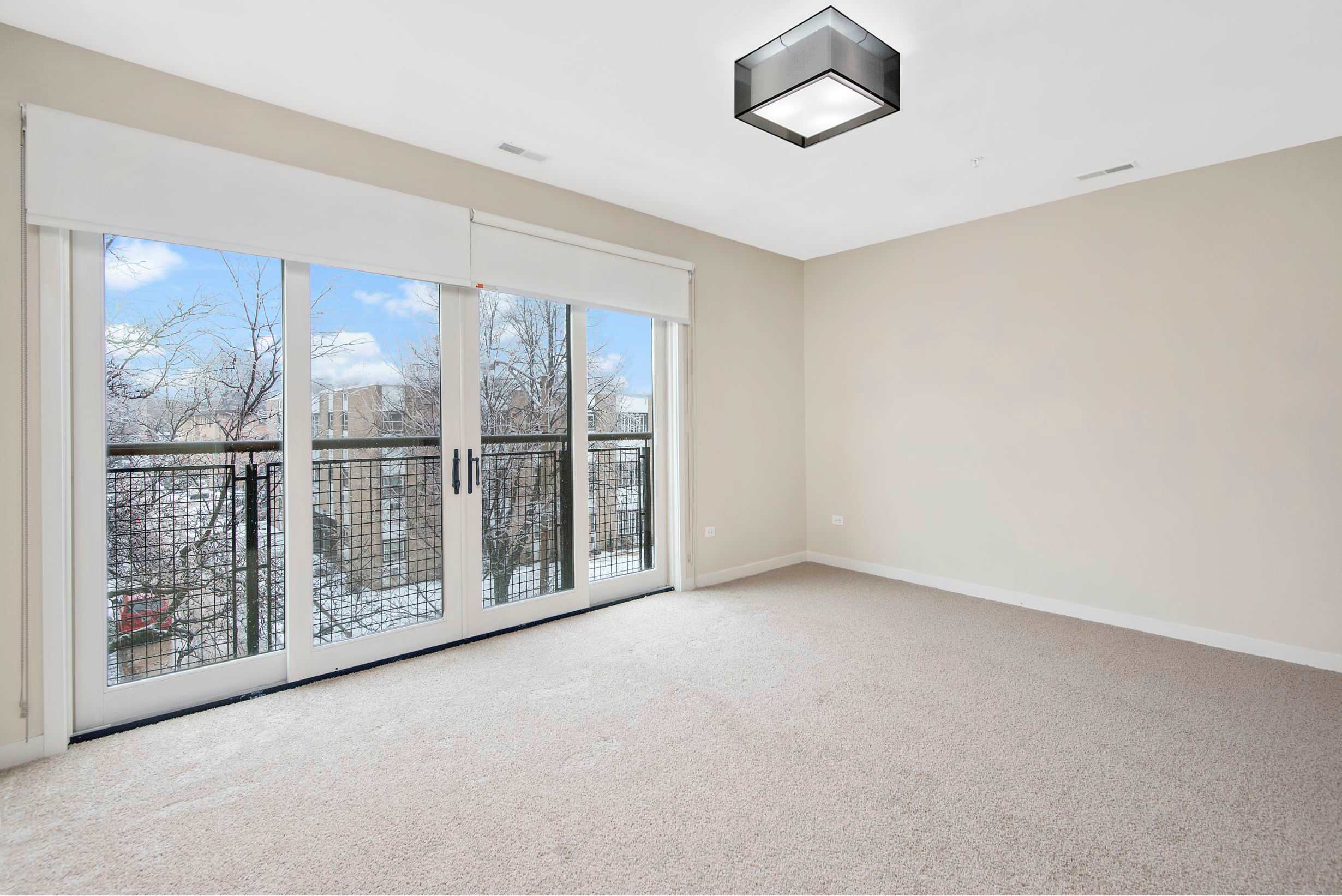 Oak Park Place apartment room with large window and patio doors - Oak Park, IL