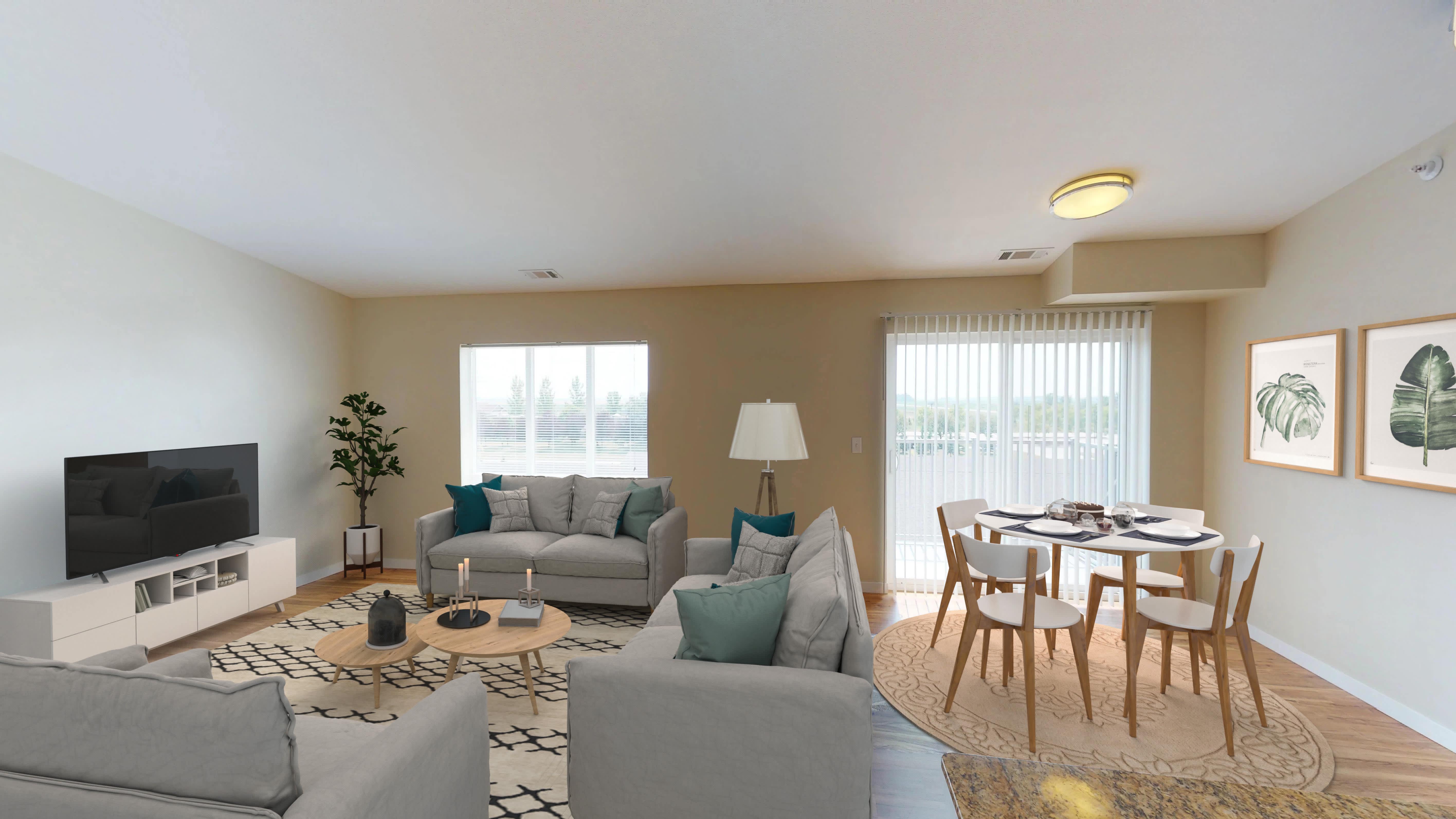 The Gardens Apartments living and dining area with patio or balcony access - Grand Forks, ND