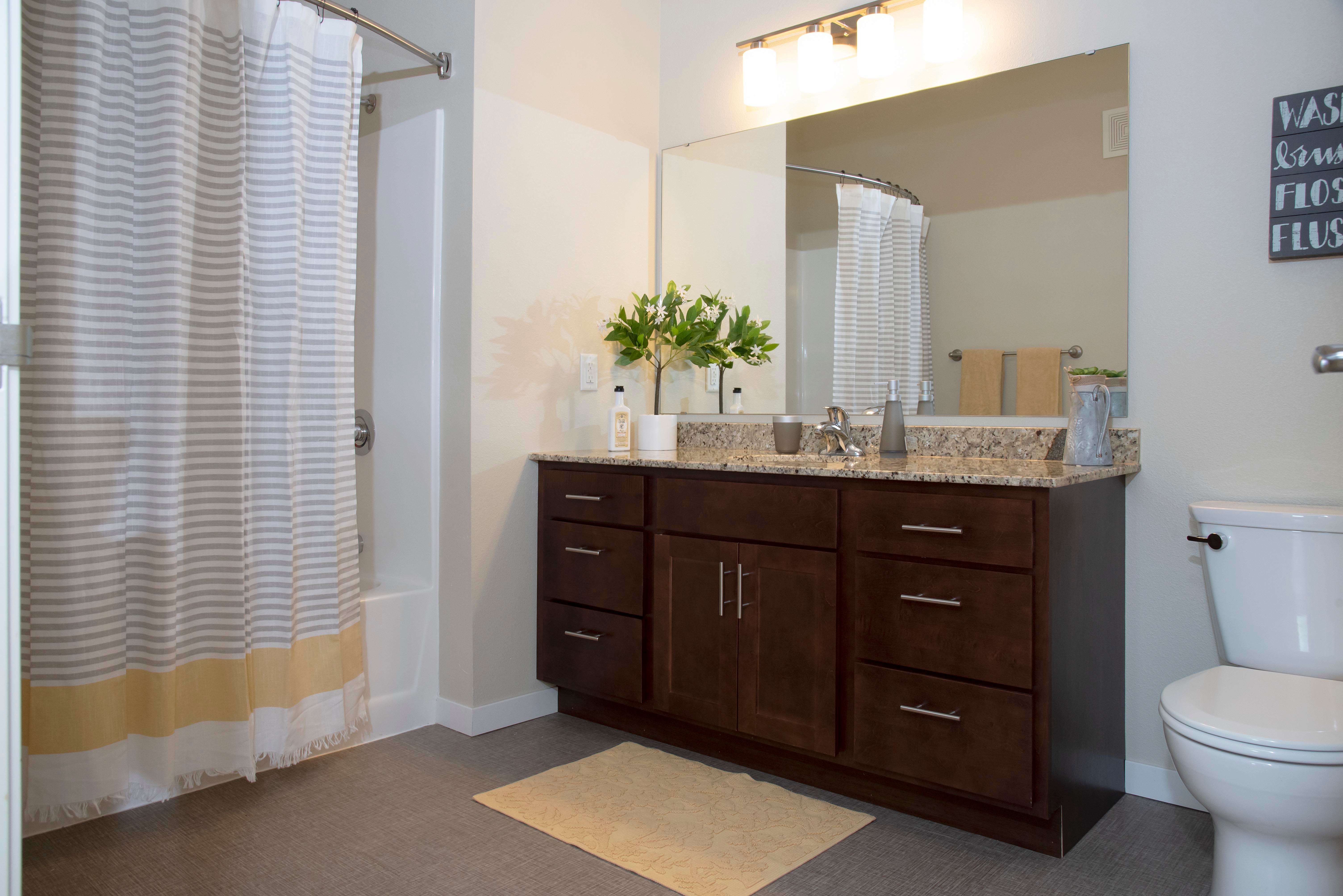 The Gardens Apartments bathroom with granite vanity - Grand Forks, ND