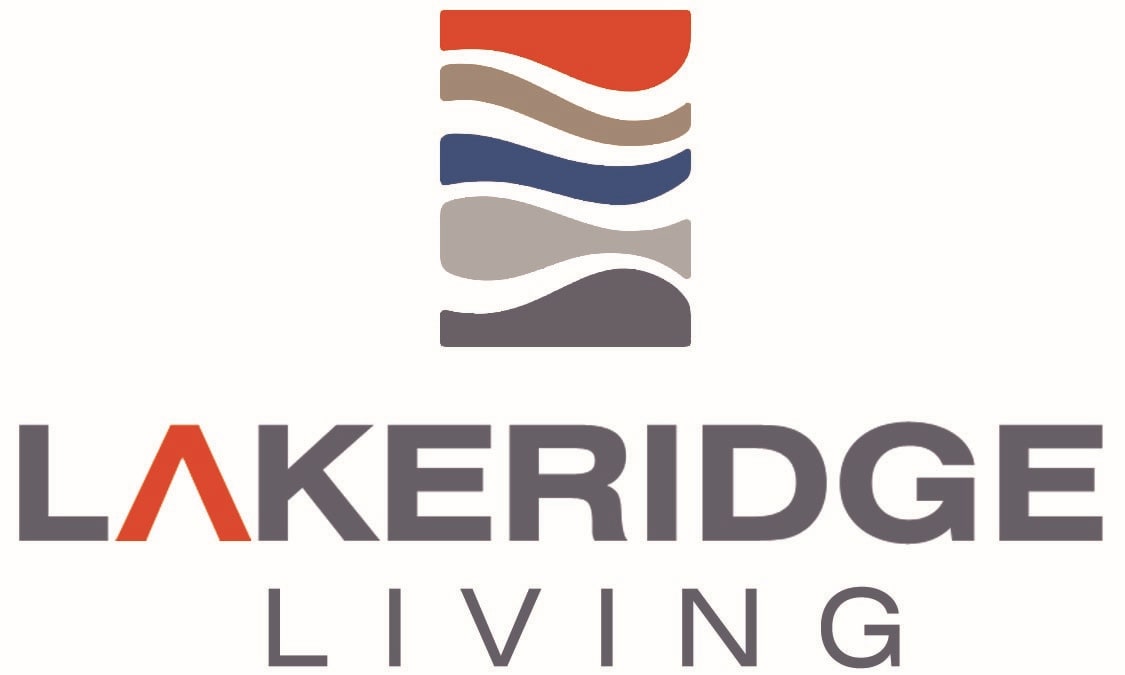 The image shows a logo with the text "LAKERIDGE LIVING" in front of a graphic of three horizontal stripes in red, white, and blue.