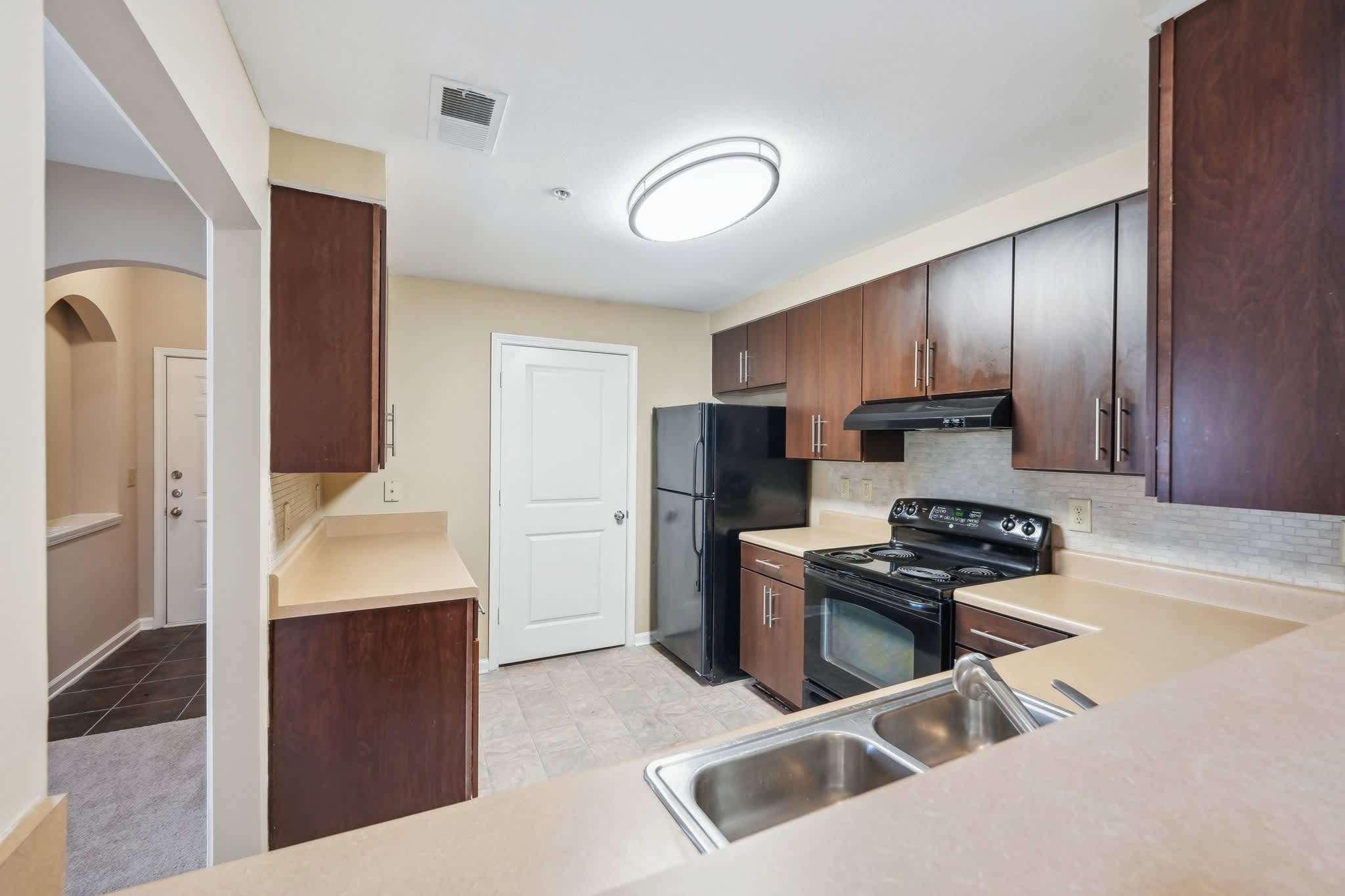 Apartment kitchen with black appliances - Stillwood Farms - Newnan, GA