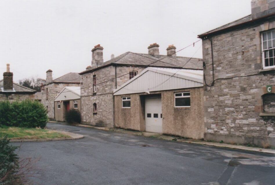 A photograph from 2004 showing the two warehouses built in the spaces between the Stables, Saddlery and Armoury