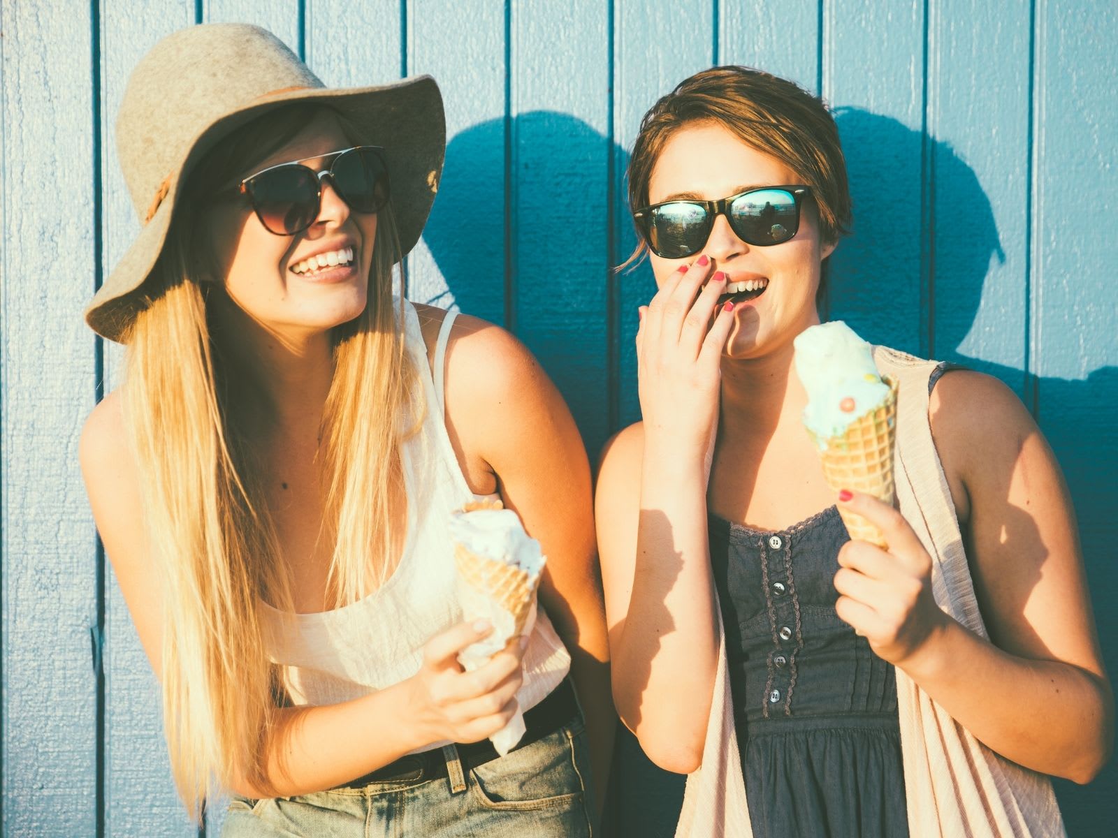 Friends laughing with ice-cream in hand