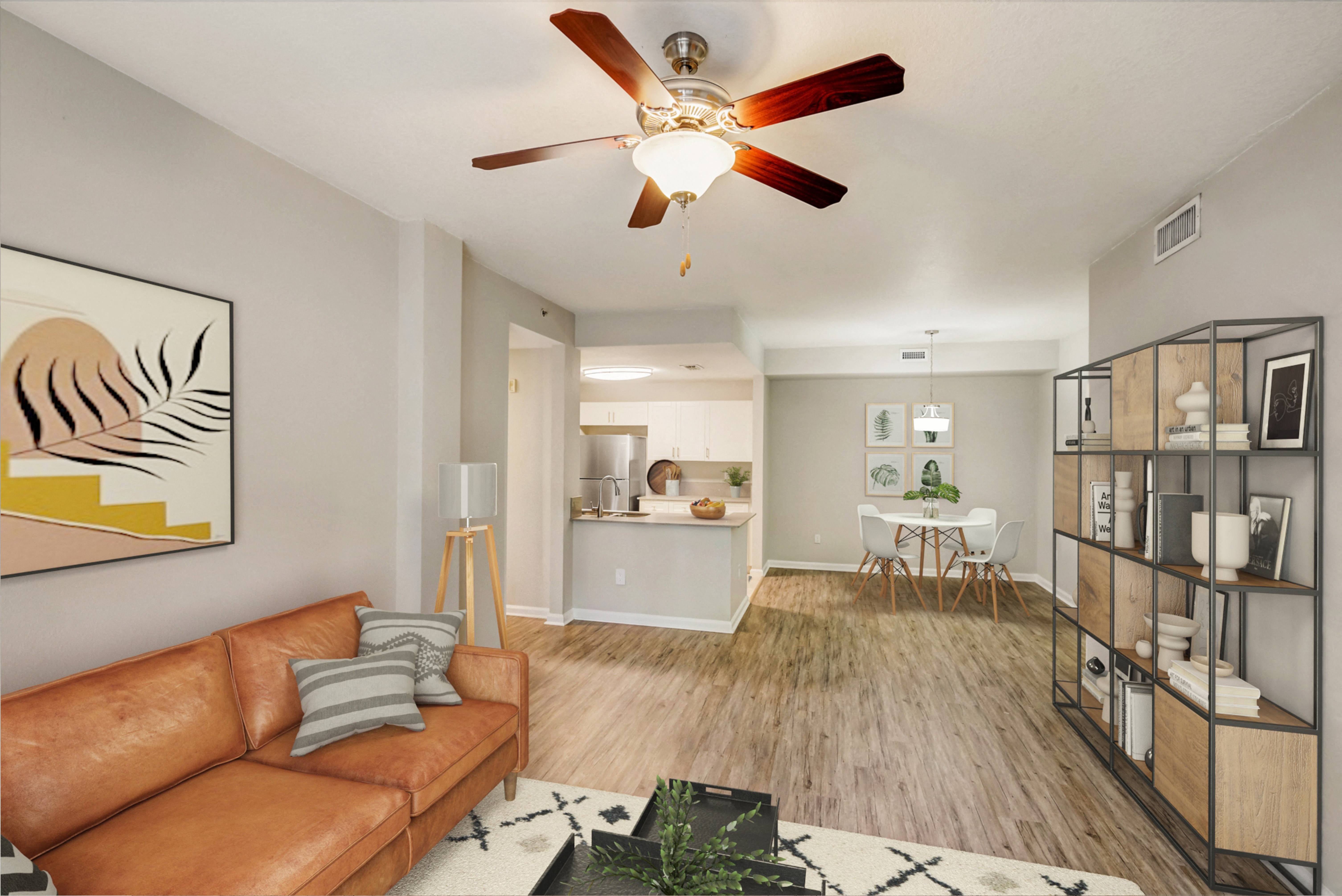 Thumbnail 2 of 34 - a living room with a couch and a ceiling fan