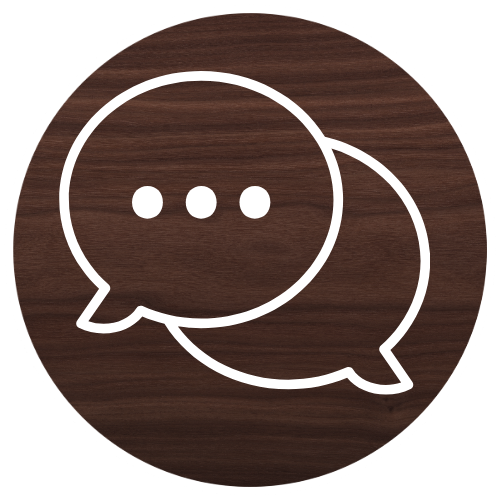 A speech bubble icon on a wooden background.