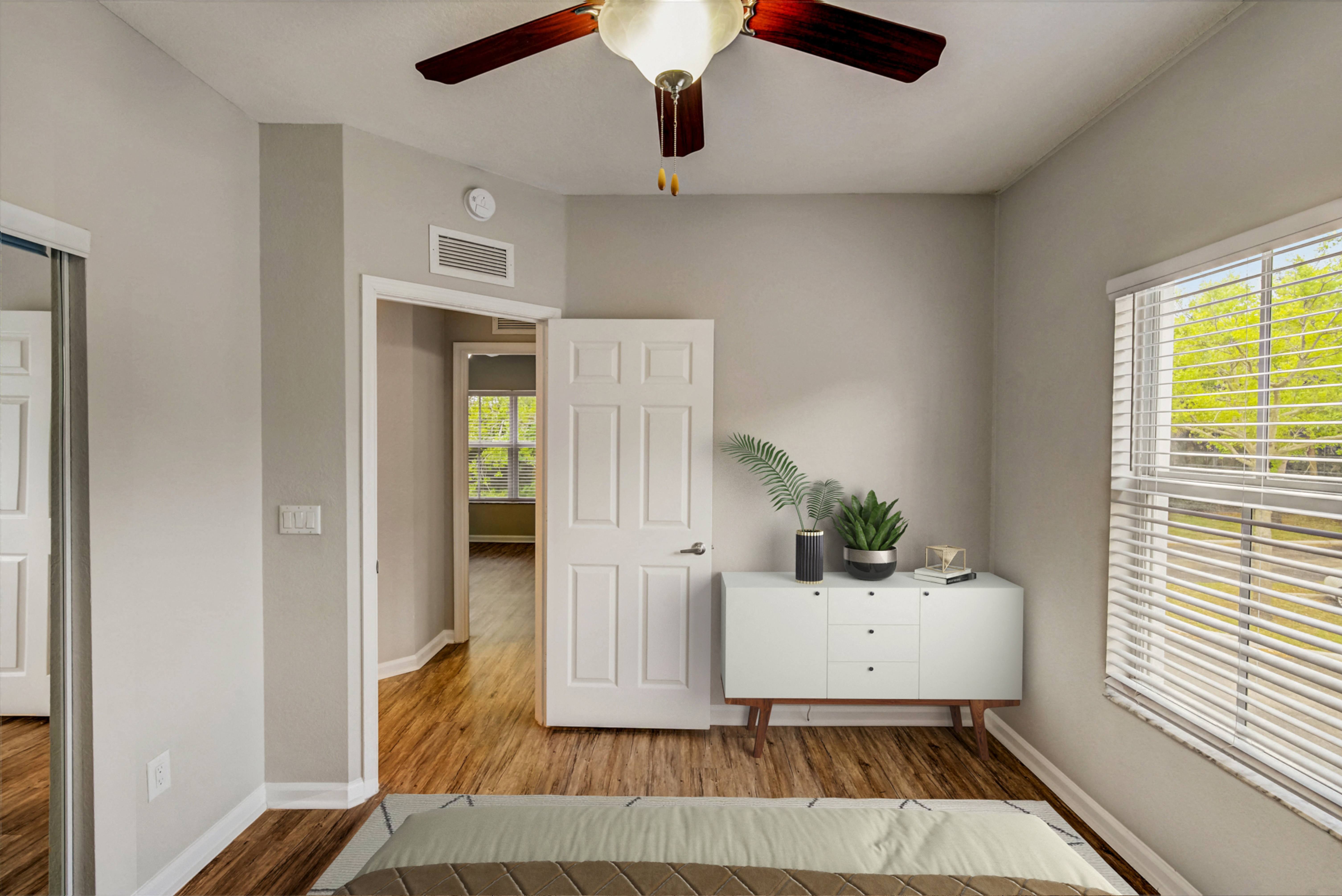 Thumbnail 7 of 34 - an empty bedroom with a ceiling fan and a white dresser