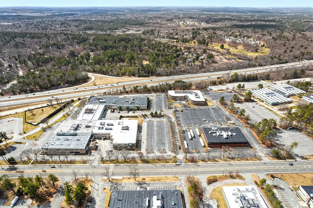 Aerial view of The Xchange Campus buildings with surrounding roads and greenery