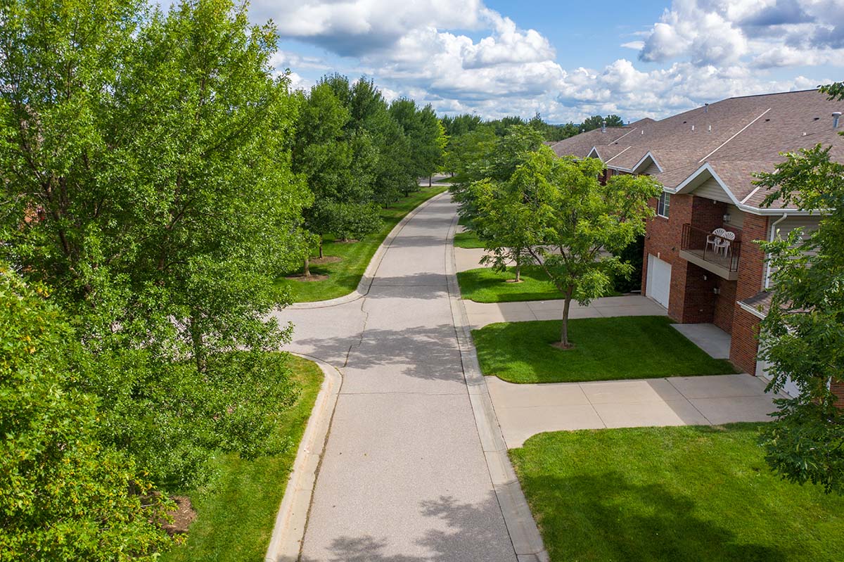 a tree lined street with apartment buildings in North Lincoln