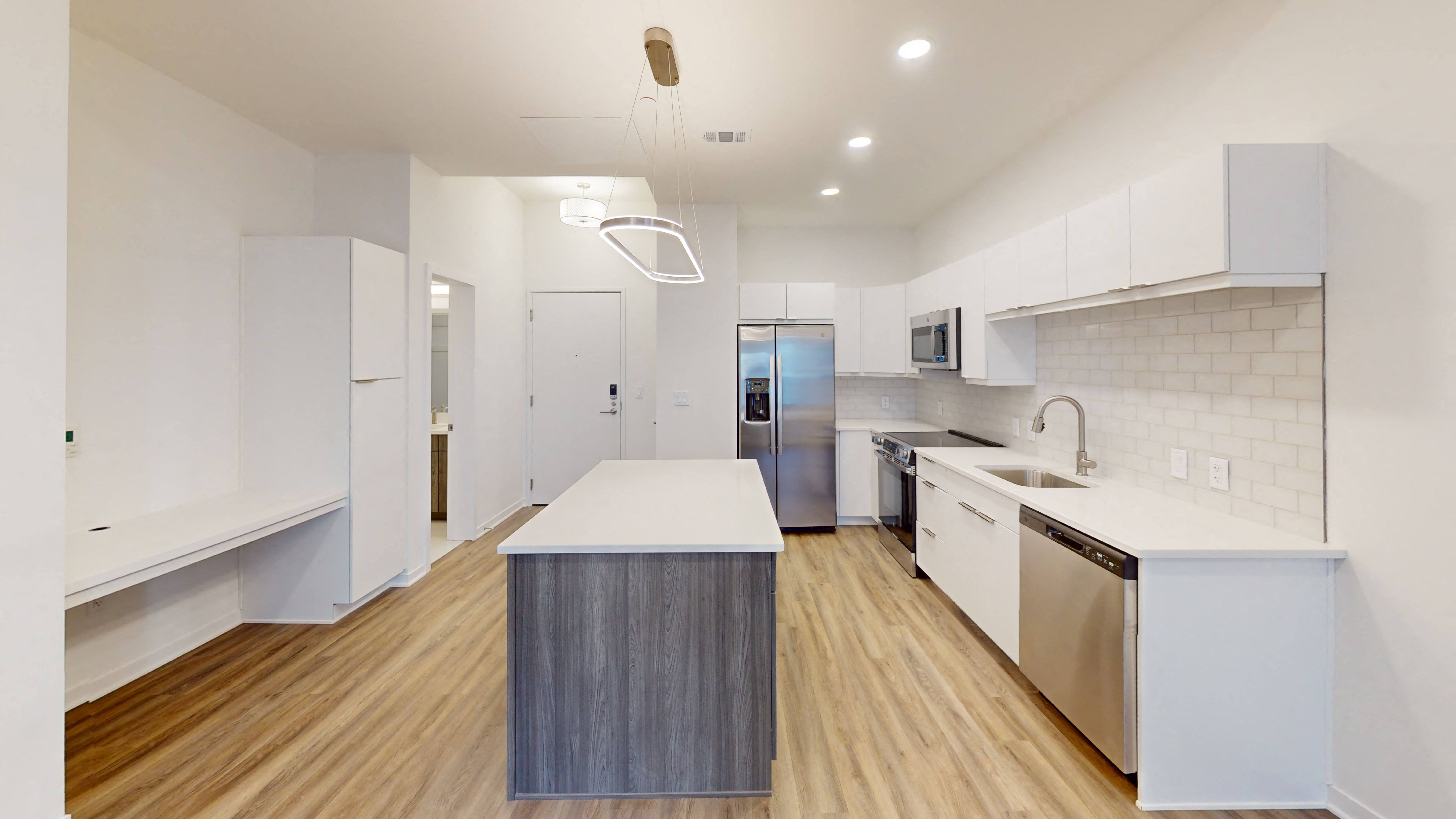 a kitchen with white cabinetry and stainless steel appliances