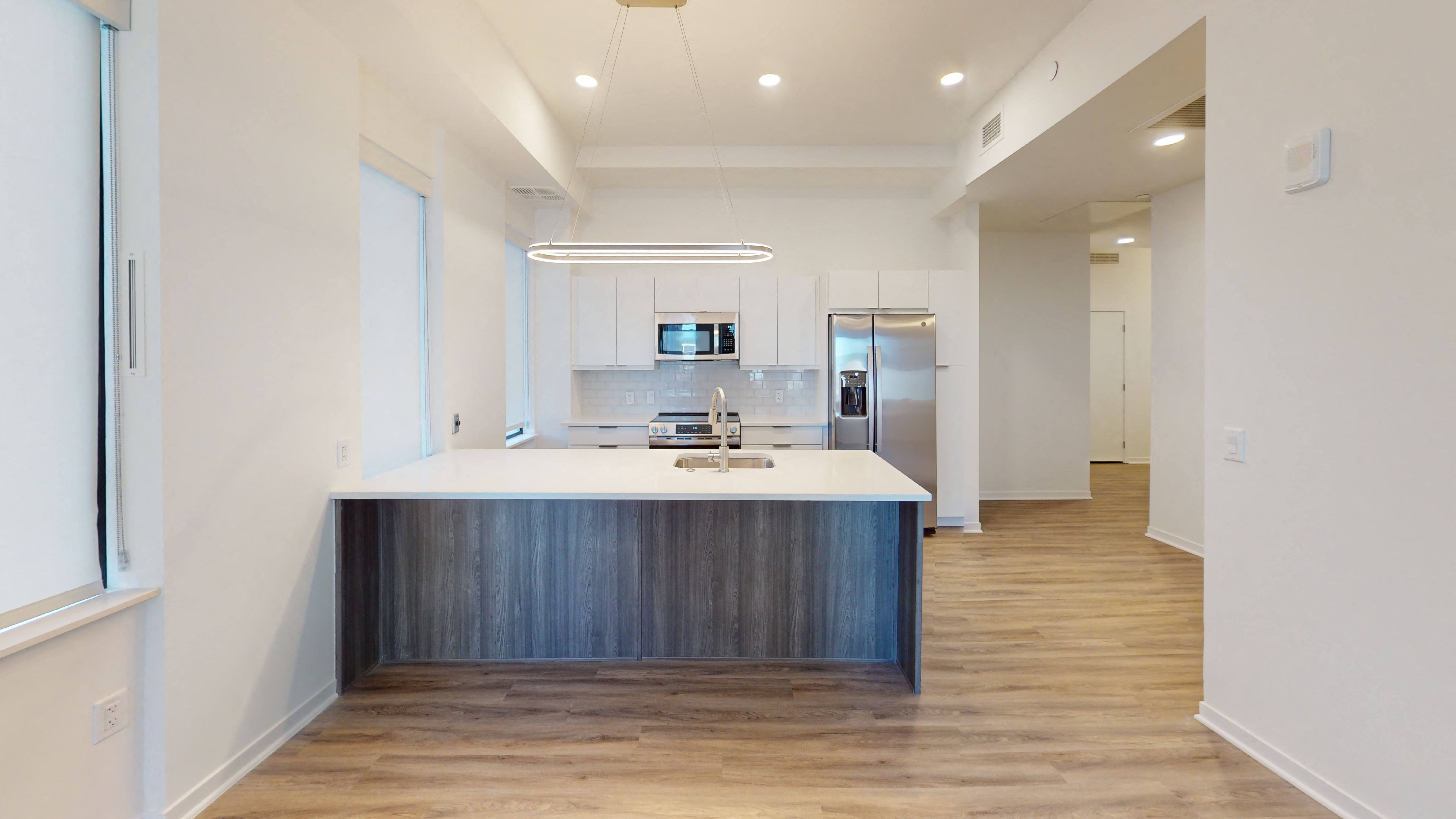 a kitchen with white cabinetry and stainless steel appliances