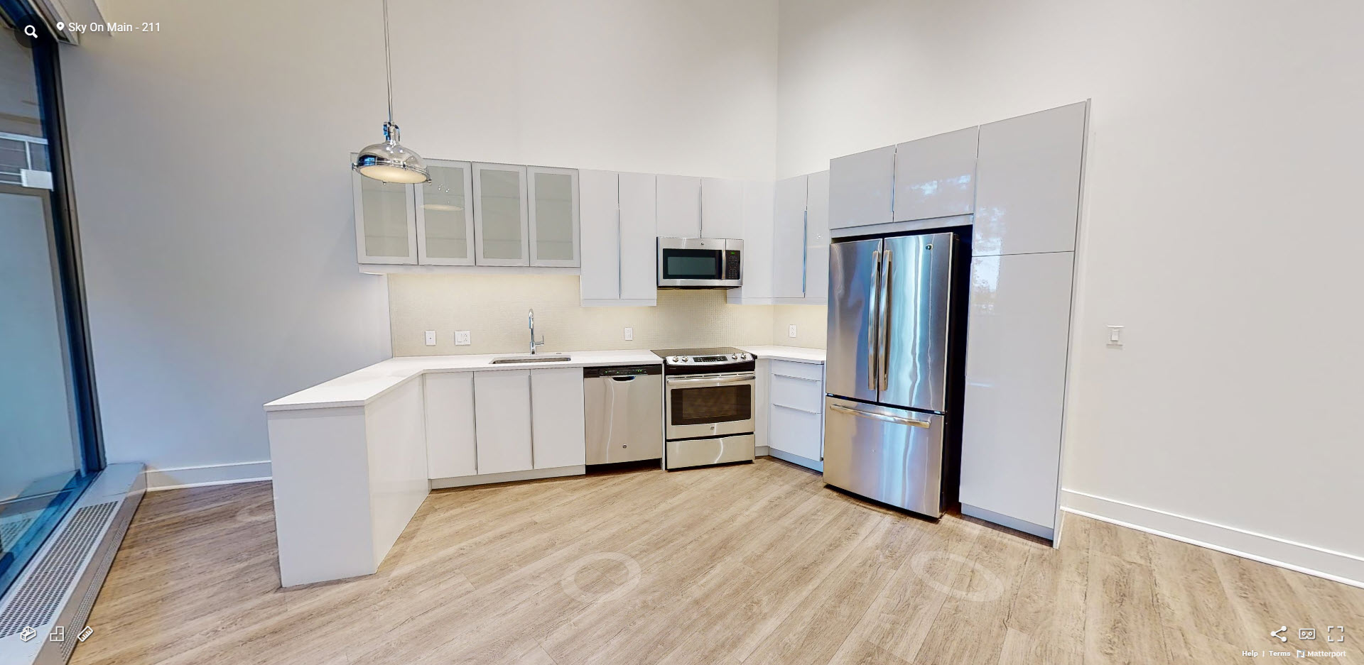 a kitchen with stainless steel appliances and a large window