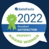 a white speech bubble with a green ribbon in it