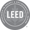 a gray and white circle with the word leed written on it