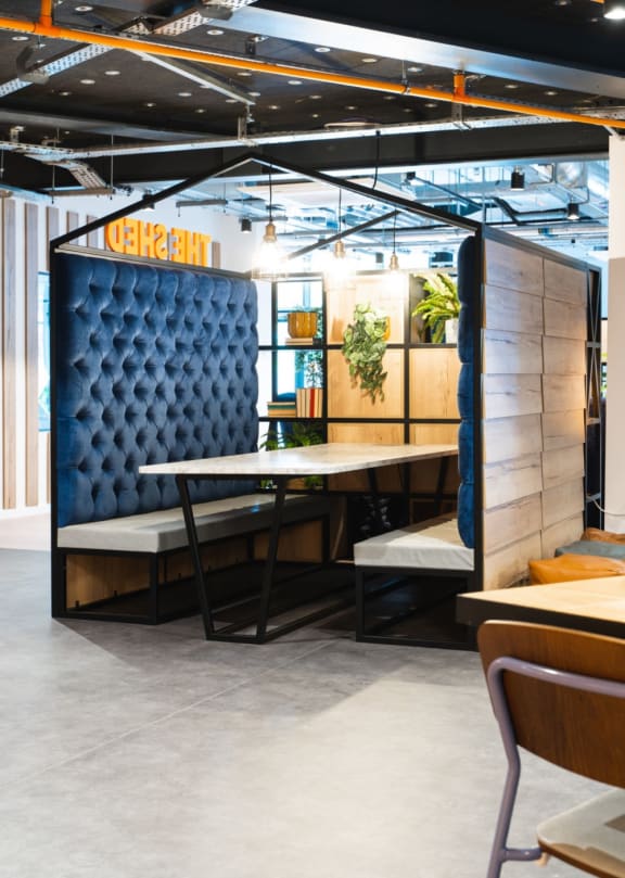 a booth in a restaurant with a table and chairs