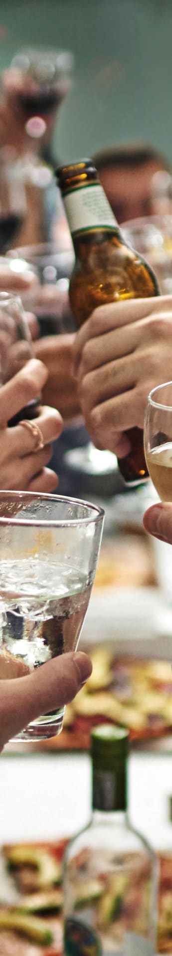 a group of people holding wine glasses over a table