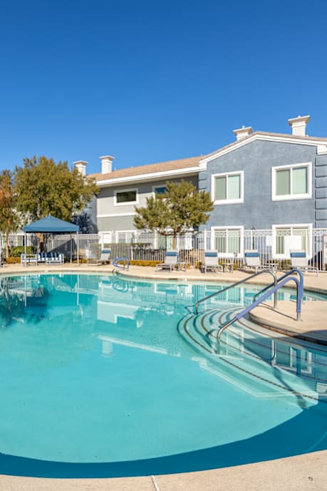 A swimming pool with a ladder in the middle of it.