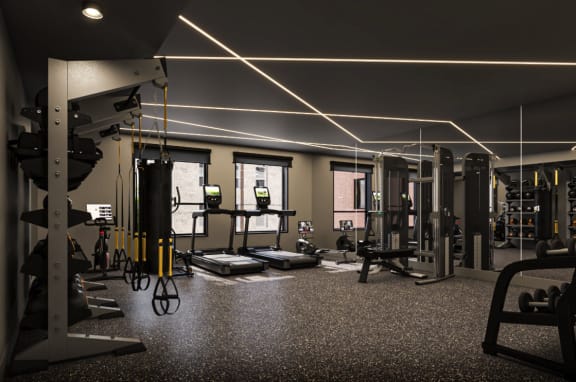 a gym with weights and other gym equipment and lights on the ceiling at Glassworks, Philadelphia, PA, 19122