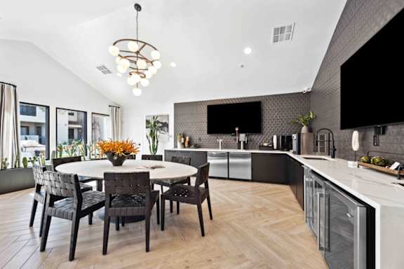 a kitchen and dining room with a table and chairs