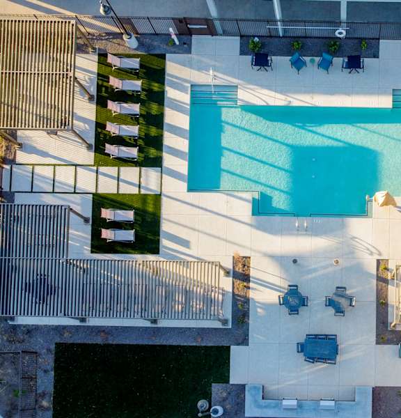 an aerial view of a pool in the middle of a building