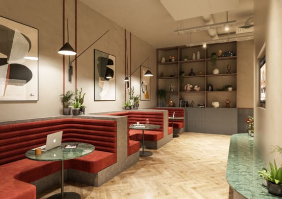 a rendering of a lounge area with red couches and tables