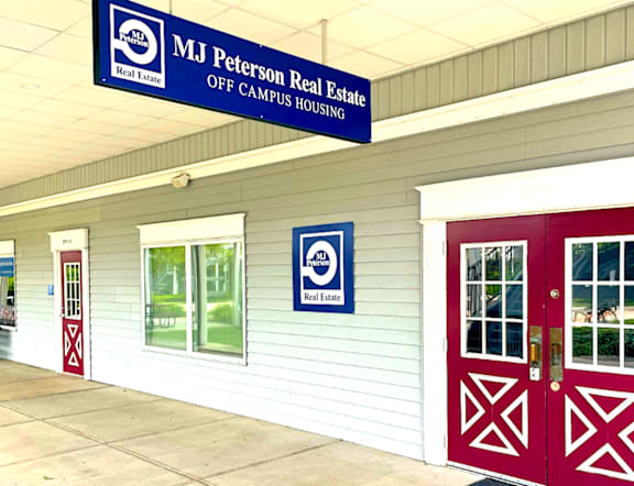 A real estate advertisement for MJ Peterson Real Estate, offering student housing simplified with options like apartments, communities, singles, condos, and duplexes, tailored to the needs of students, and located at UB