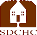 A graphic of a house with two hands on either side.
