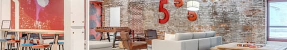 A room with a brick wall and a white column.