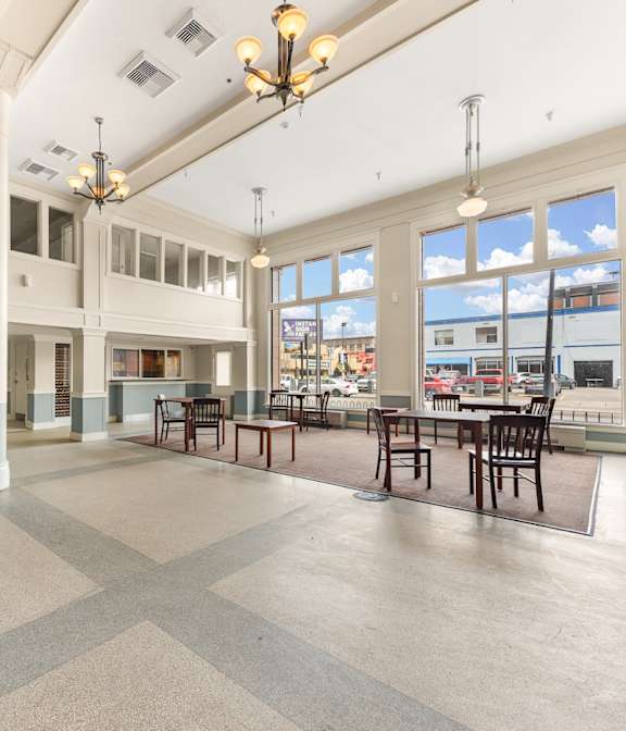 A large open space with tables and chairs and a balcony at 206 Flats, Spokane, 99201