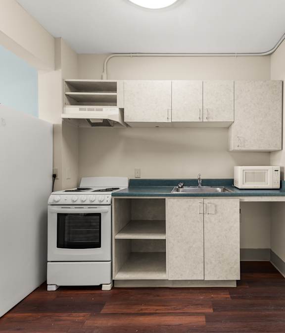 A kitchen with white appliances and cabinets at 206 Flats, Spokane Washington .