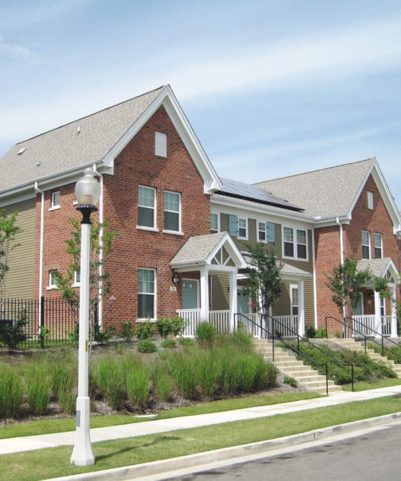 a row of brick homes on the side of a street