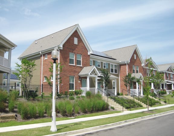 a row of brick homes on the side of a street