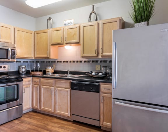 a kitchen with stainless steel appliances and wooden cabinets