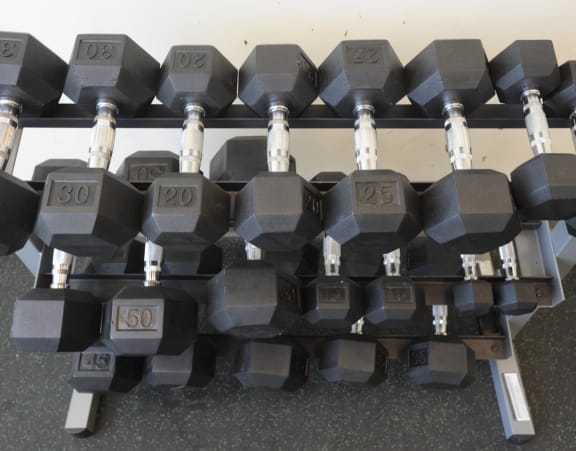 a pile of dumbbells stacked on top of each other