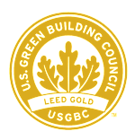The image is of a logo for the U.S. Green Building Council, featuring a circular design with a green background and a yellow border.