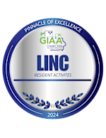 A building with a sign that says "Pinnacle of Excellence Awards 2024 Award Winner Resident Activities LINC at Gray's Station".