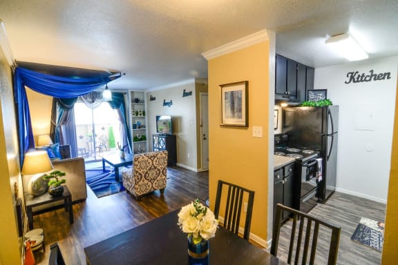 a view of the living room and kitchen from the dining room