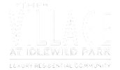 A black and white image of a sign for "The Village at Idlewild Park".