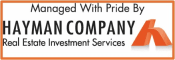 a sign that says managed with pride by the hawman company real estate investment services