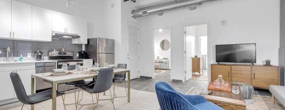 A modern kitchen with a dining table and chairs.