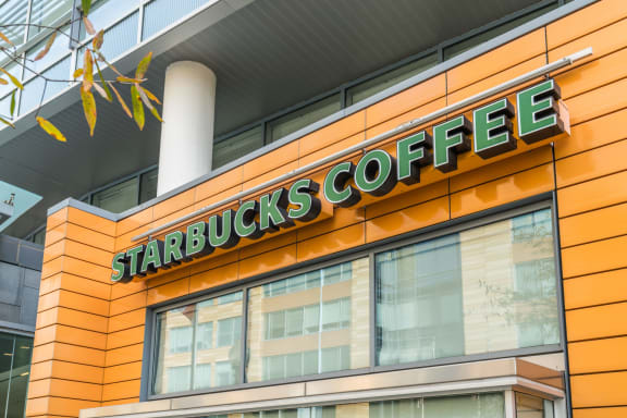 a picture of a starbucks coffee sign on the side of a building at Valo in Washington, DC 20024