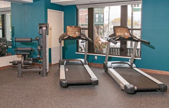 a room with two treadmills and two exercise bikes