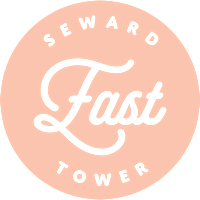 A logo with the words "Seward Fast Tower" written in a cursive font.