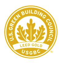 The image is of a logo for the U.S. Green Building Council, featuring a circular design with a green background and a yellow border.