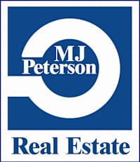 a white and blue real estate sign with the words real estate