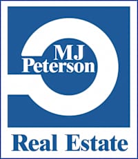 a white and blue real estate sign with the word real estate in a white circle