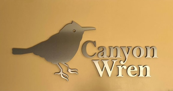 a metal bird on a wall with the words can you win