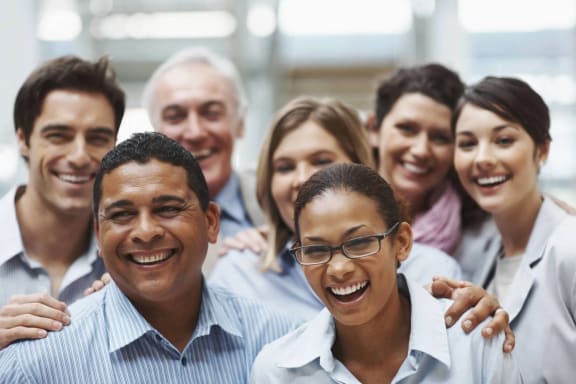 a group of people smiling and posing for a photo